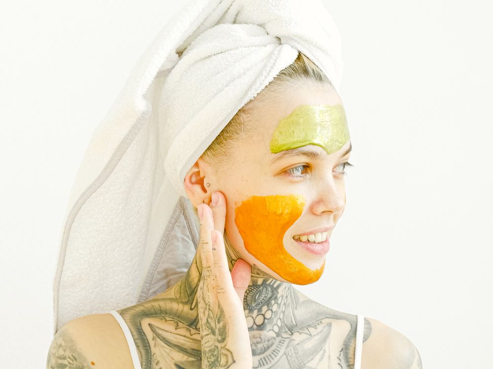 Woman applying a facial skincare treatment